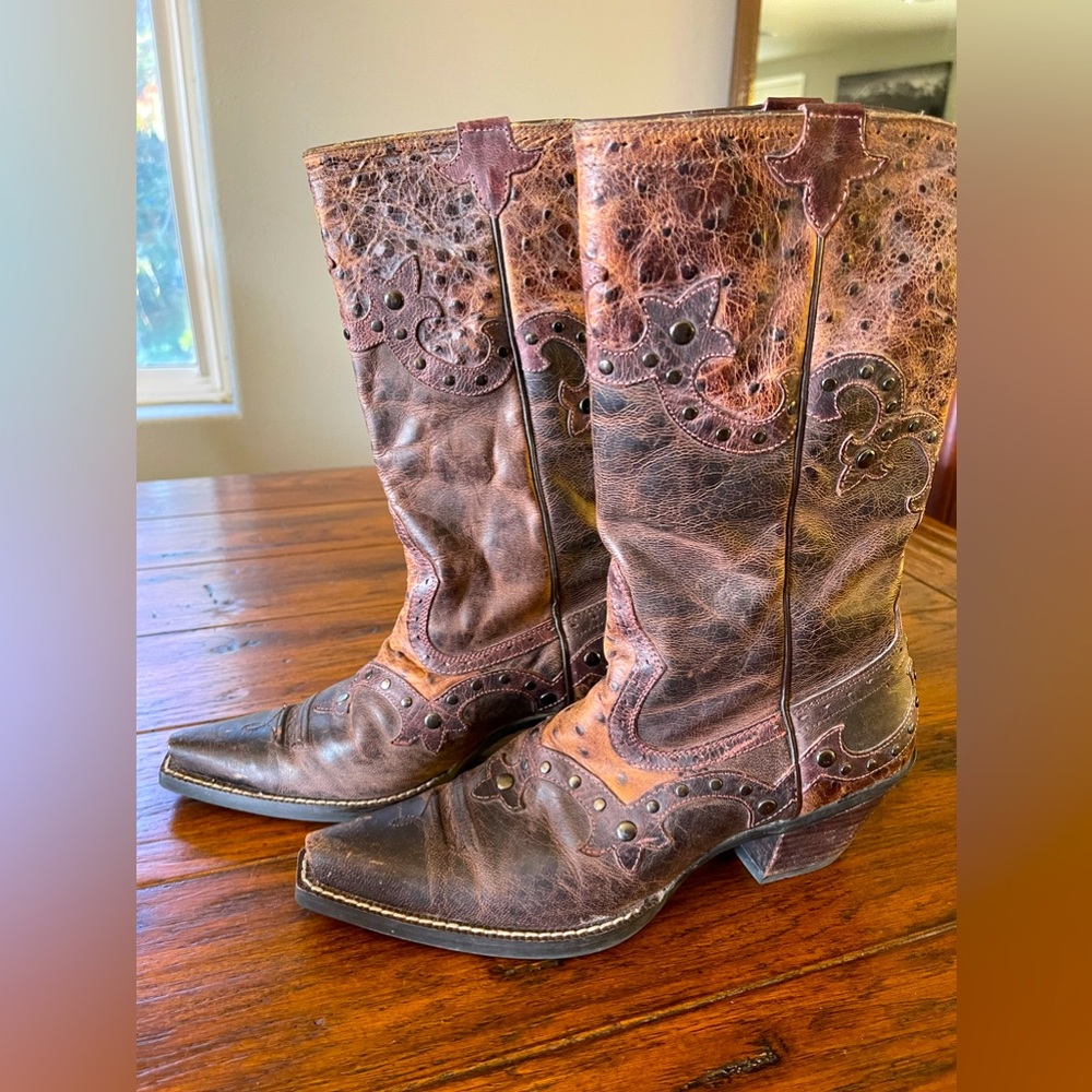 Ariat size 7B brown leather cowboy boots with pink stitching and metal accents.
